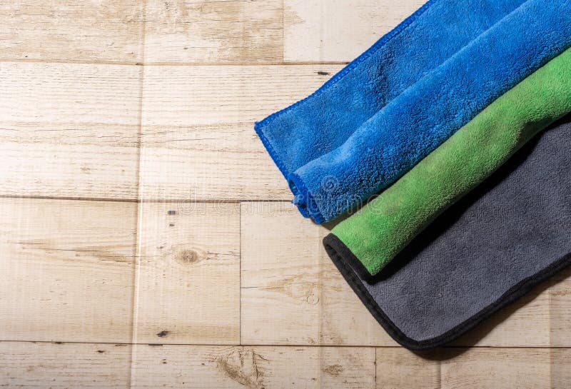 Microfiber Ceiling Cleaning and Rubbing an Hardwood Floor with a Microfiber Cloth Stock Image