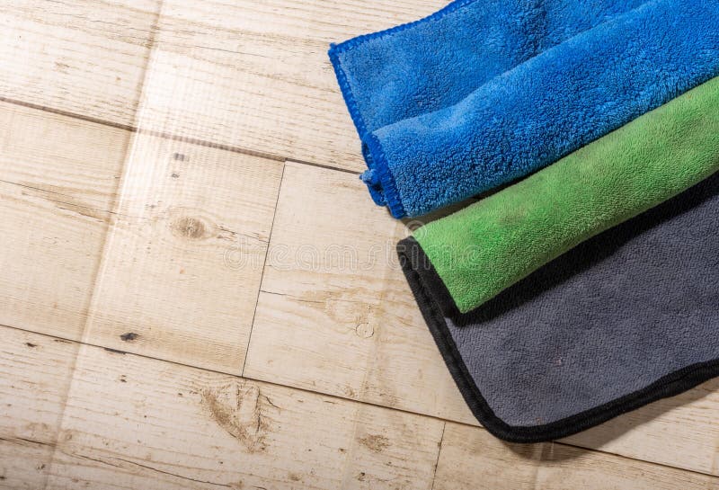 Microfiber Ceiling Cleaning and Rubbing an Hardwood Floor with a Microfiber Cloth Stock Photo
