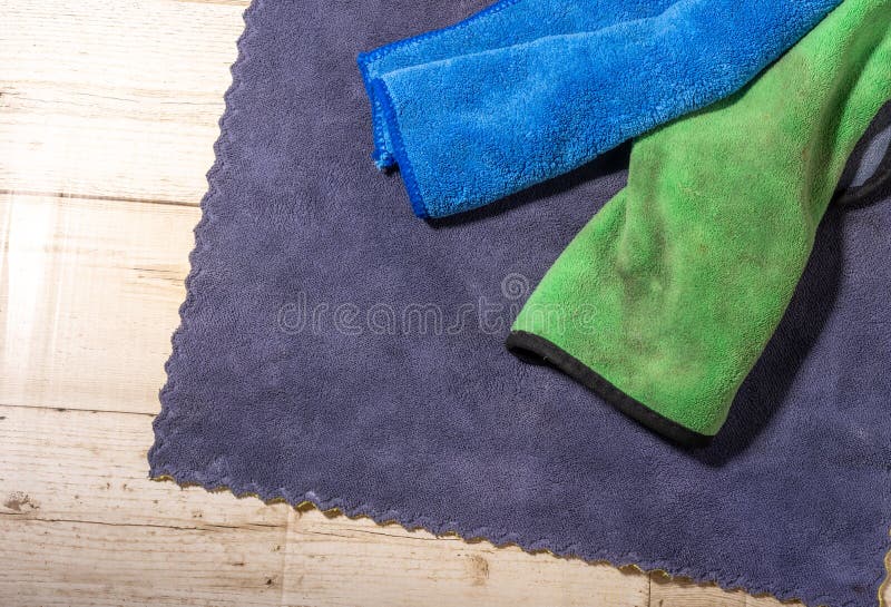Microfiber Ceiling Cleaning and Rubbing an Hardwood Floor with a Microfiber Cloth Stock Photo