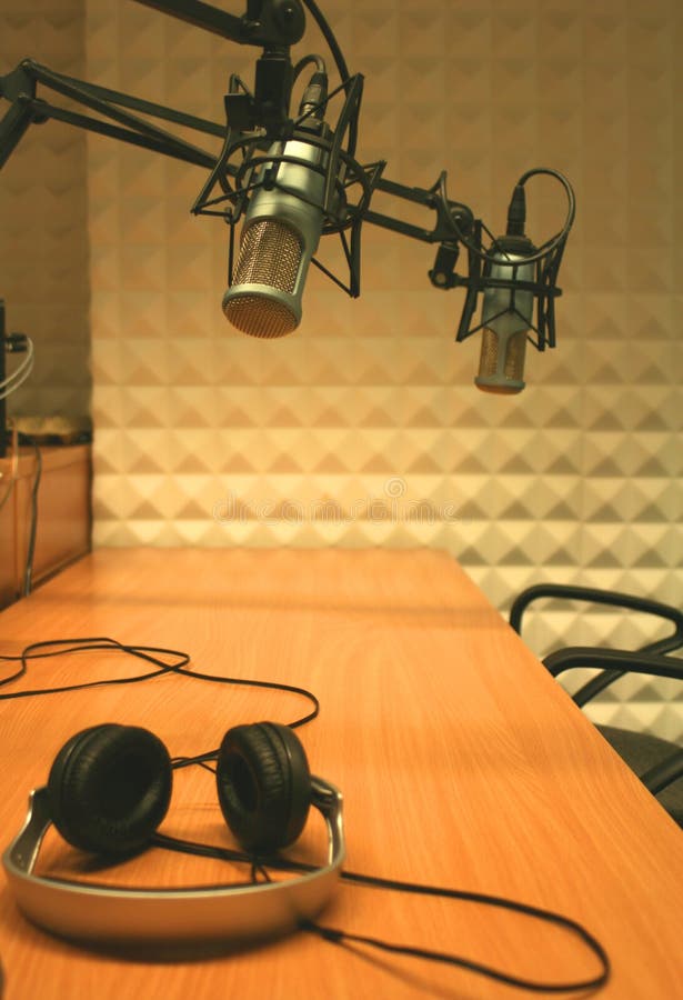 Two microphones and headphones in a radio stdio. Two microphones and headphones in a radio stdio