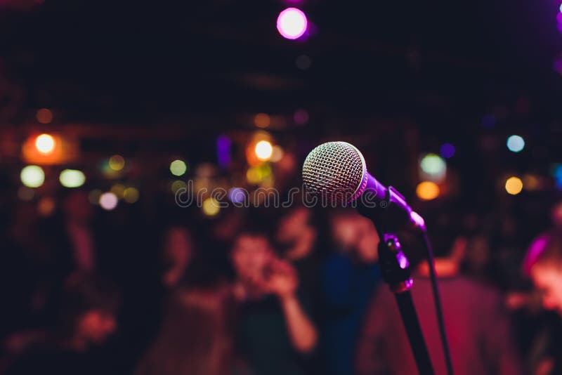 Microphone with blurred colorful bright light in dark night background, soft focus image for business technology communication royalty free stock photos Microphone with blurred colorful bright light in dark night background, soft focus image for business technology communication royalty free stock photos