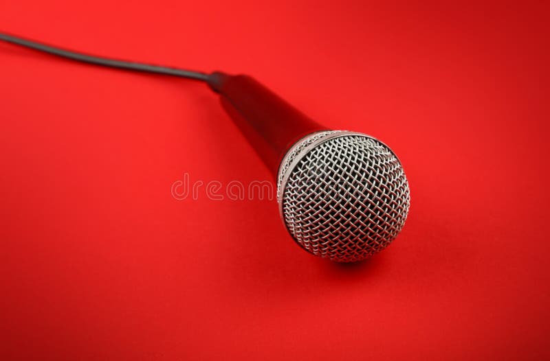 Microphone with cable high angle close up over red