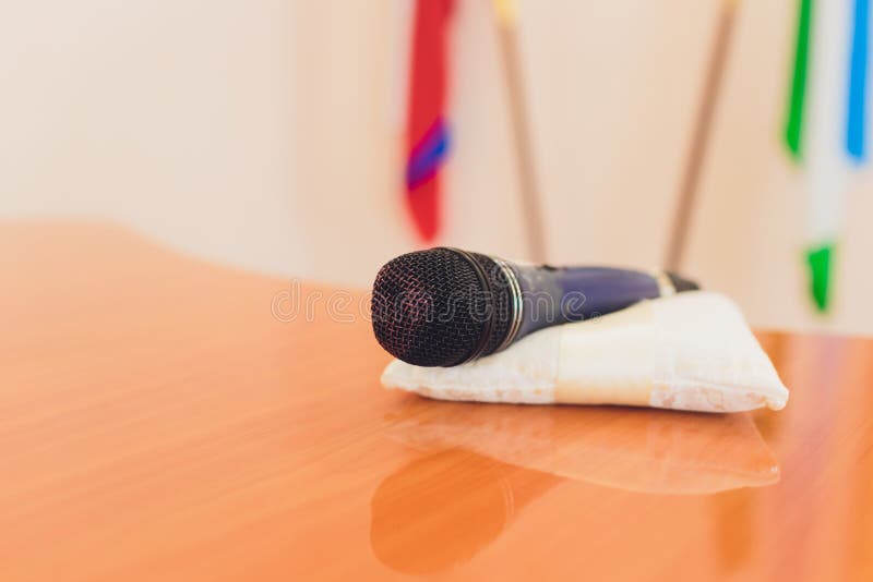Microphone is Placed on a Wooden Table. at the Meeting Room. Stock