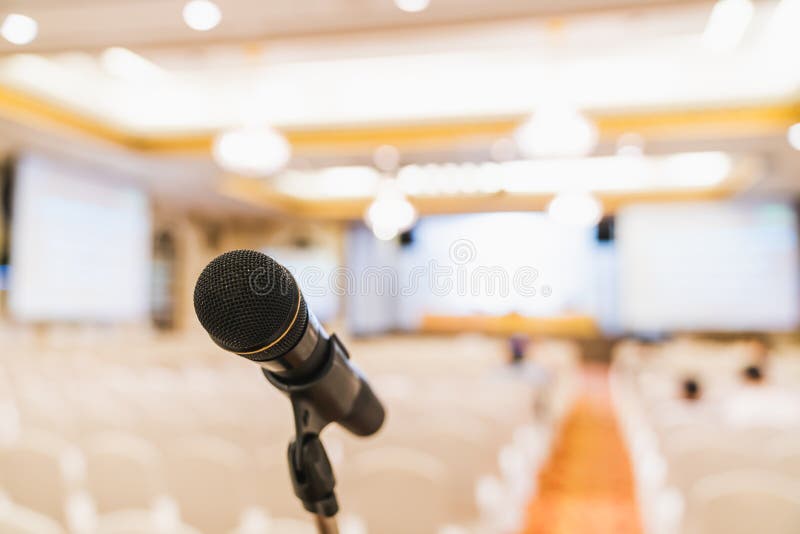 Microphone stand in conference hall blurred background with copy space. Public announcement event, Organization company meeting