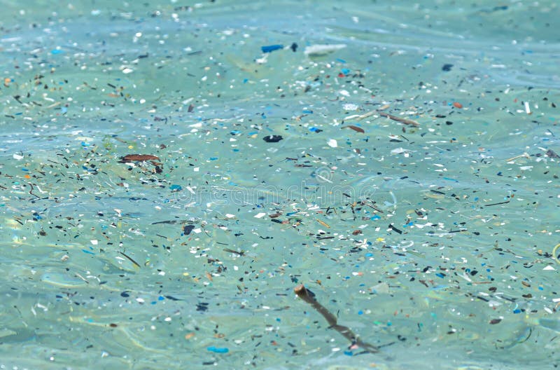 microplastic particles float in the ocean, water pollution