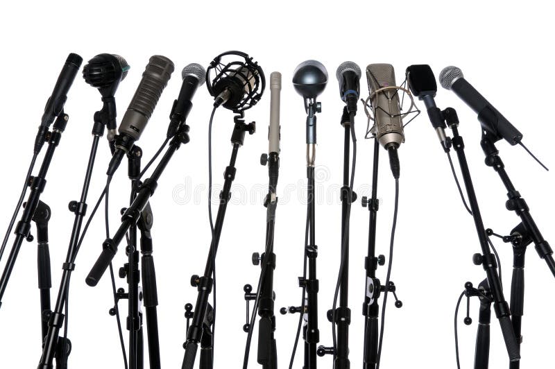 Microphones aligned together isolated over a white background. Microphones aligned together isolated over a white background