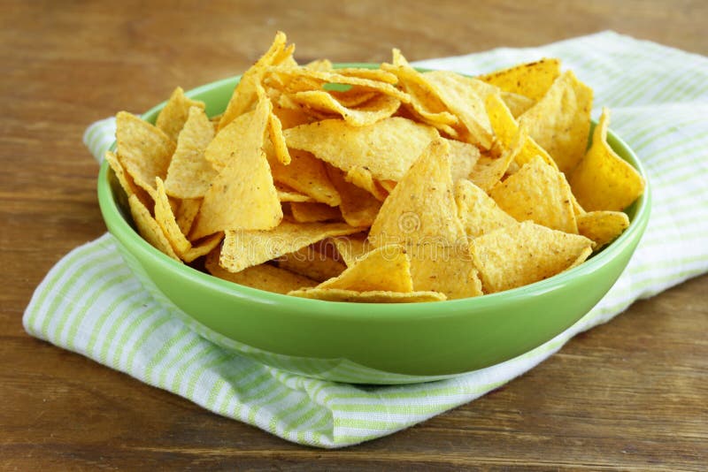 Microprocesadores de maíz (nachos) en un cuenco verde foto de archivo Microprocesadores de maíz (nachos) en un cuenco verde foto de archivo