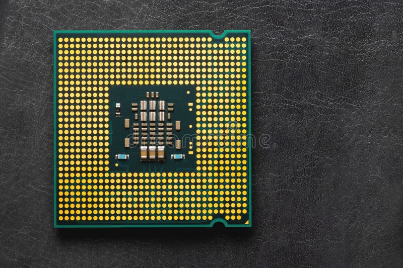 The microprocessor processor of the CPU of a computer or laptop lies on a dark matte surface. Close-up. Electronic and