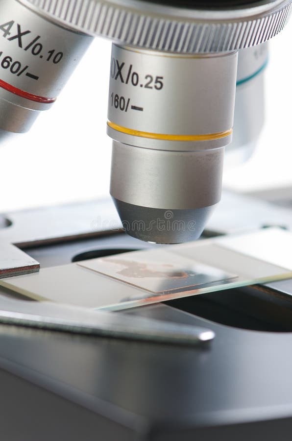 A microscope and slides against white background. Microscope slides images stock images, royalty-free photos and pictures