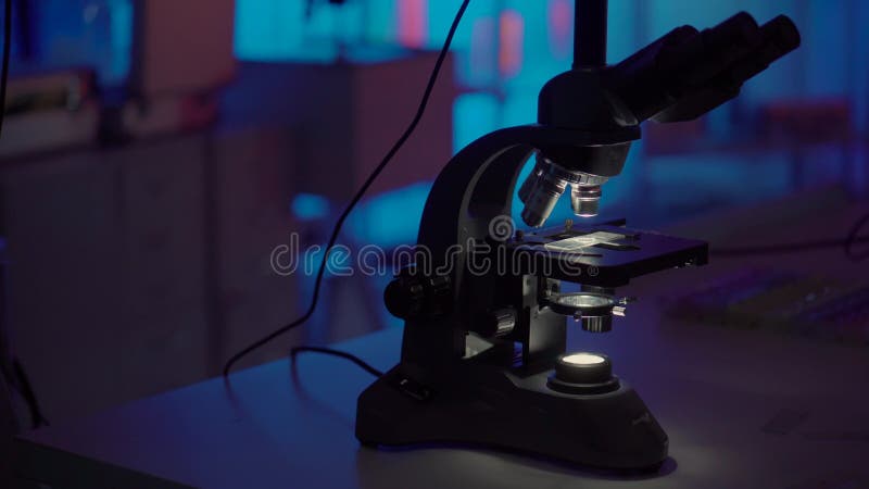 Microscopes de la Science dans le laboratoire futuriste foncé, se tenant sur la table