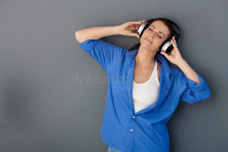 Mid-adult happy woman with headphones