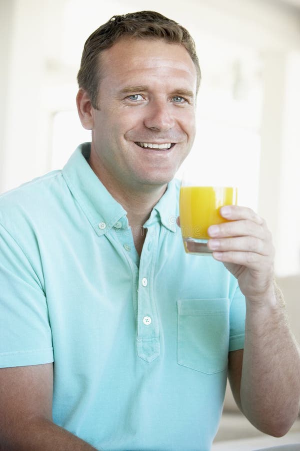 Mid Adult Man Drinking Orange Juice stock photos Mid Adult Man Drinking Orange Juice stock photos