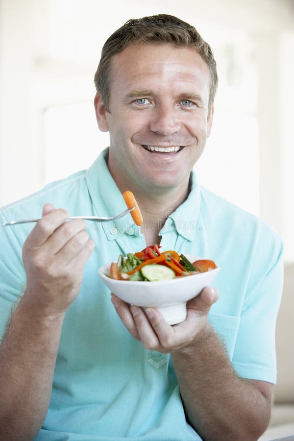 Mid Adult Man Eating A Salad royalty free stock photo Mid Adult Man Eating A Salad royalty free stock photo