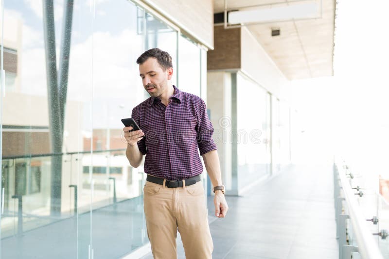Man With Mobile Phone Checking Internet Application In Shopping stock image Man With Mobile Phone Checking Internet Application In Shopping stock image