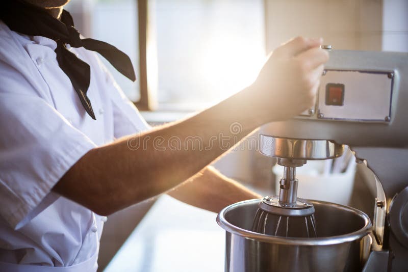 Mid section of chef blending the batter in mixing blender stock images Mid section of chef blending the batter in mixing blender stock images