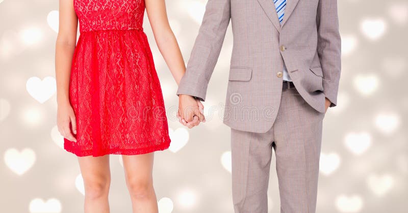 Mid-section of romantic couple holding hands. Mid-section of romantic couple holding hands