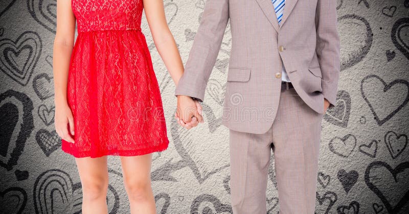 VMid-section of couple holding hands against digitally generated heart background