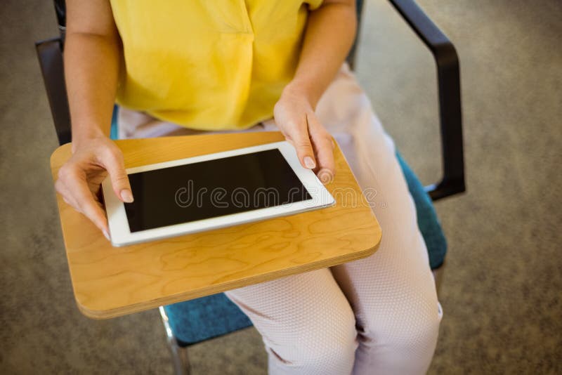 Mid-section Of Female Business Executive Using Digital Tablet