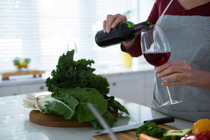 Mid section of woman having red wine at table stock image Mid section of woman having red wine at table stock image