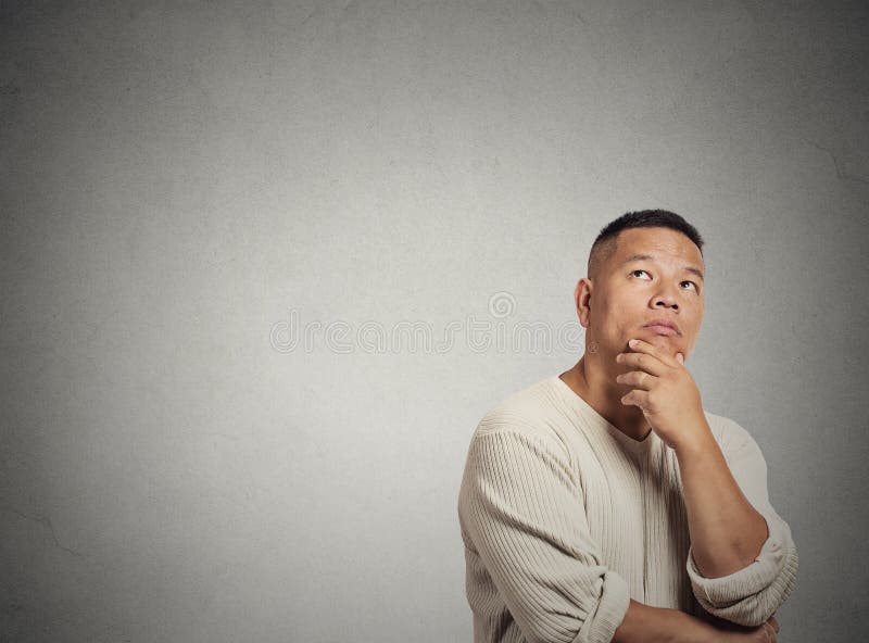 Portrait headshot handsome middle aged man thinking looking up isolated grey wall background with copy space. Human face expressions, emotions, feelings, body language, perception. Portrait headshot handsome middle aged man thinking looking up isolated grey wall background with copy space. Human face expressions, emotions, feelings, body language, perception