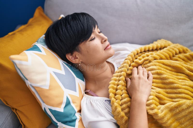 Middle Age Chinese Woman Lying on Bed Sleeping at Home Stock Photo