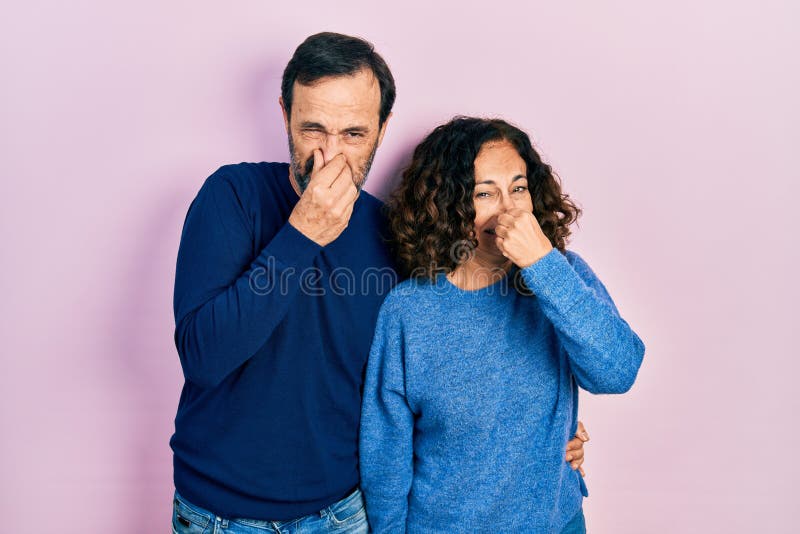 Middle Age Couple Of Hispanic Woman And Man Hugging And Standing