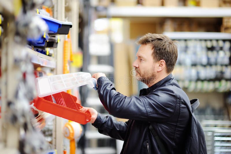 Middle Age Man Choosing the Right Tool Box in a Hardware Store Stock