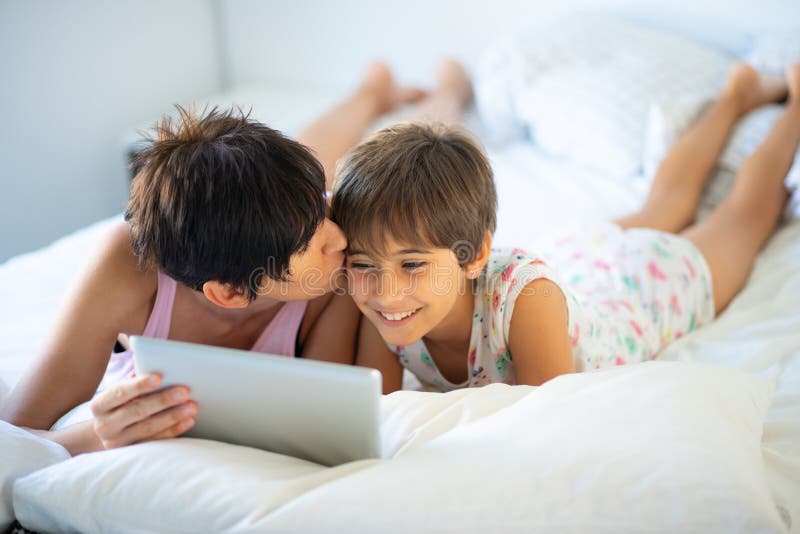 Middle Age Mother With Her Eight Years Daughter Using Digital Tablet In