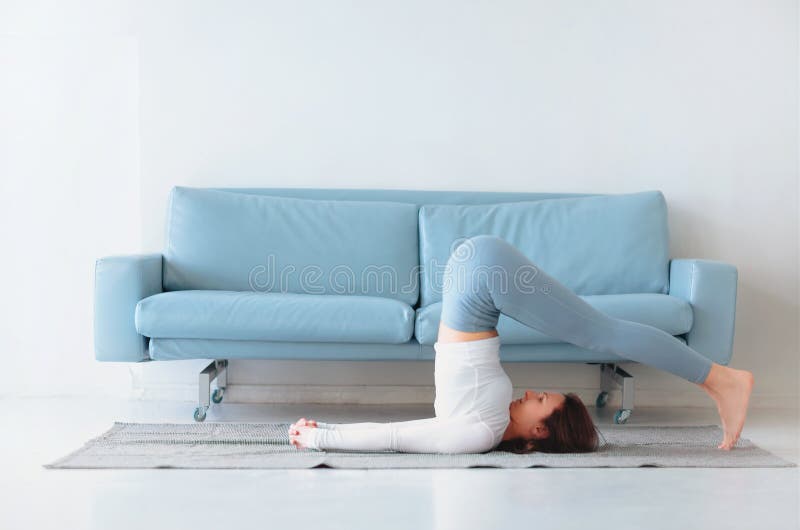 Middle age woman having yoga session at home