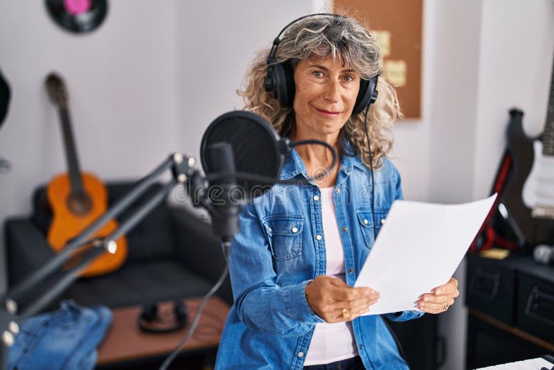 Middle Age Woman Singer Singing Song at Music Studio Stock Photo