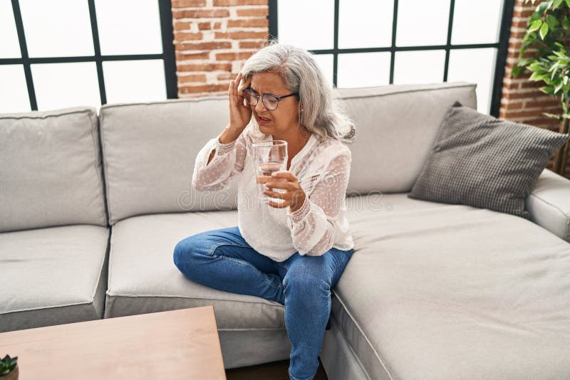 Middle Age Woman Suffering for Headache Drinking Water at Home Stock Photo Image of unhappy