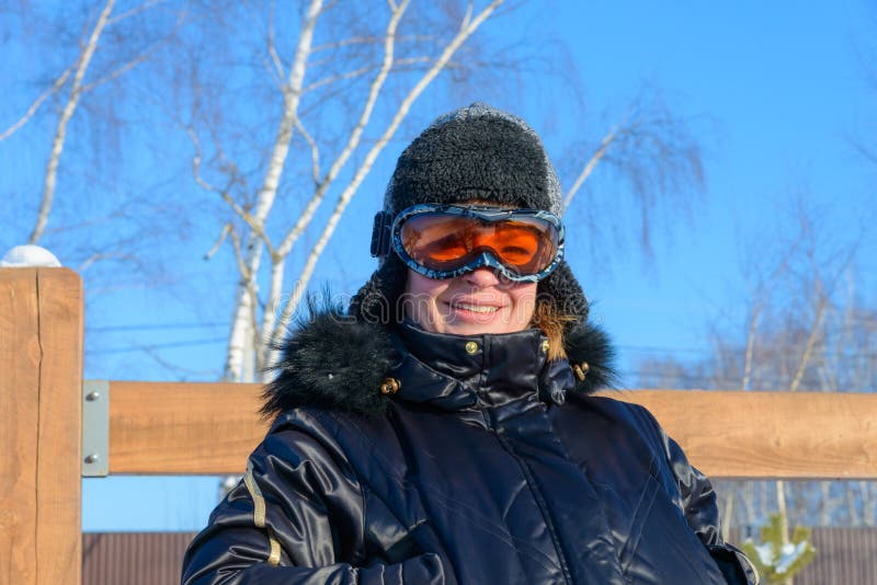 Middleaged on a Hillside in a Cap and Ski Goggles Stock Image