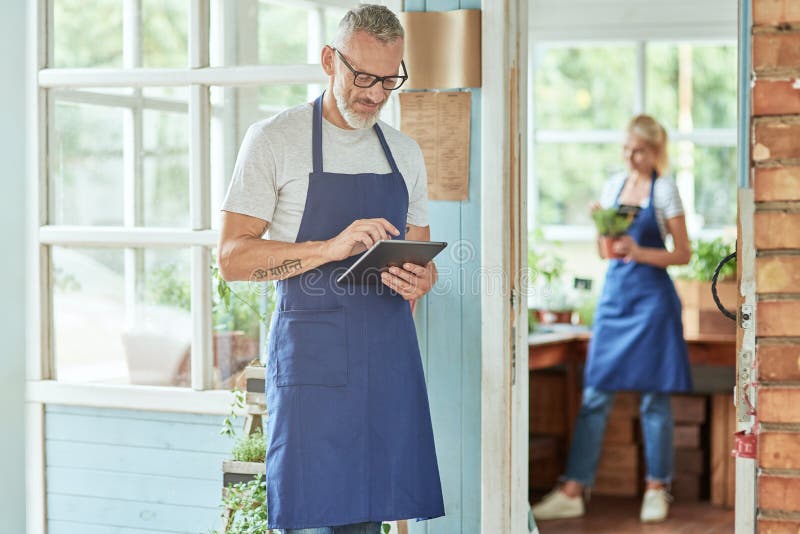 Middle aged caucasian man working in garden house