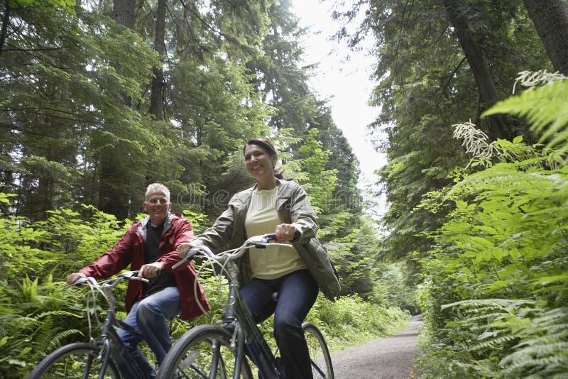 Middle Aged Couple With Bikes In Forest