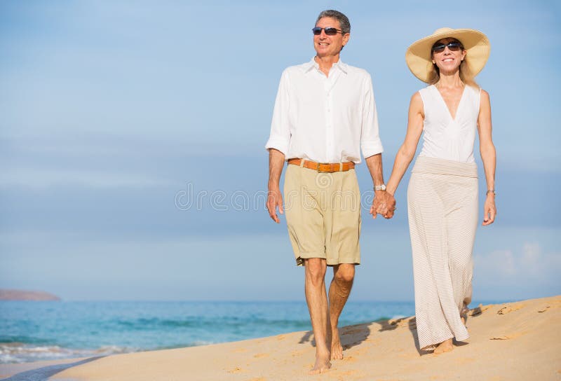 Middle Aged Couple Enjoying Walk on the Beach