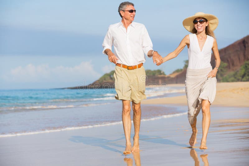 Middle Aged Couple Enjoying Walk on the Beach