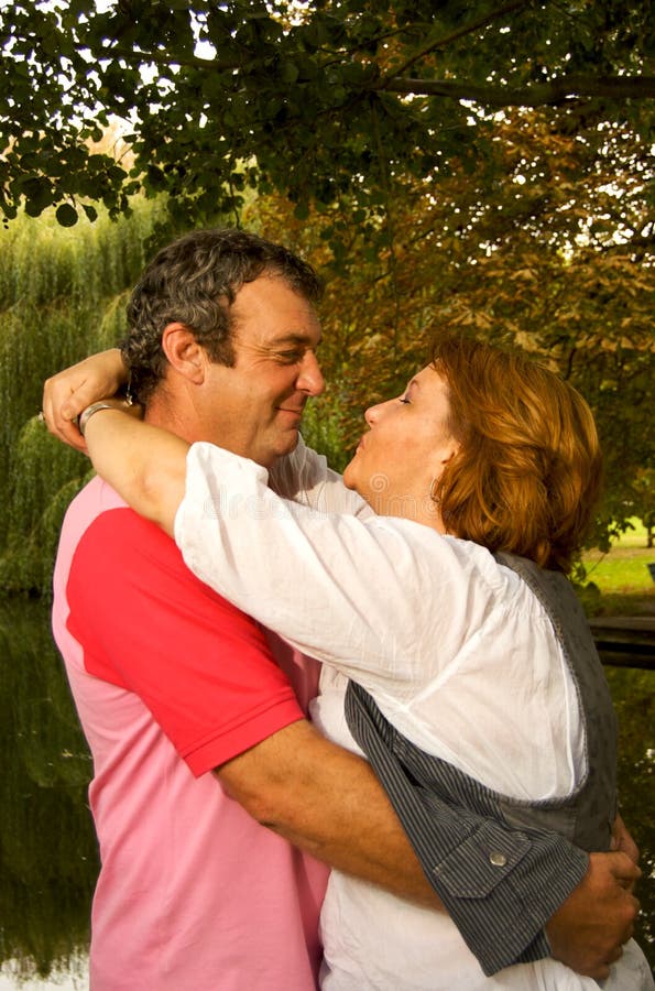 Middle Aged Couple Kissing stock photo. Image of casually 12438916