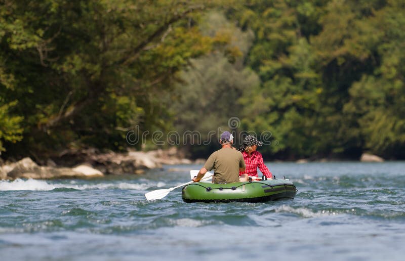 Middle aged couple rafting