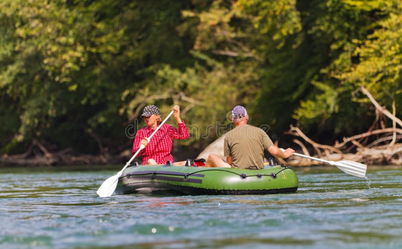 Middle aged couple rafting