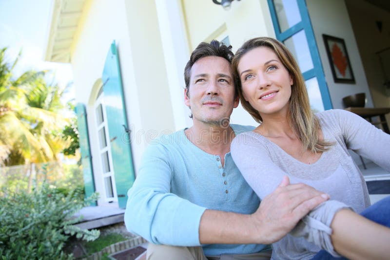 Middle-aged couple sitting in their garden