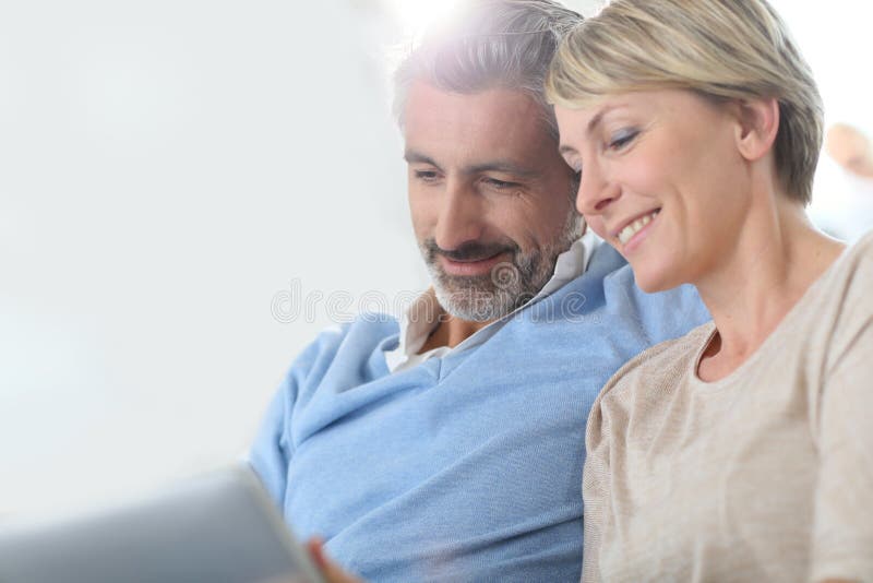 Middle-aged couple websurfing together