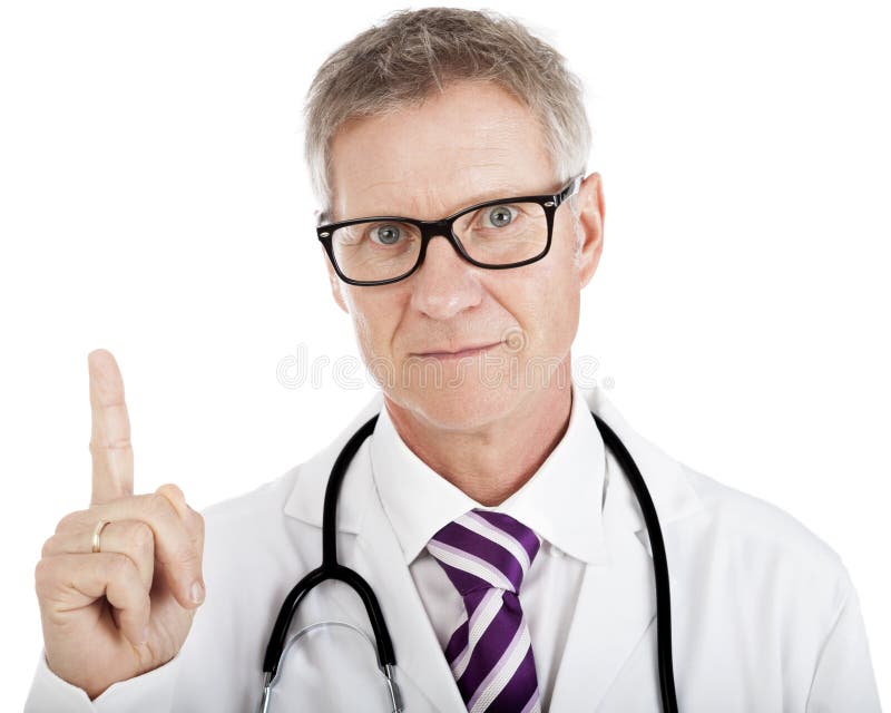 Middle-aged doctor pointing above his head towards blank white copyspace while looking at the camera with an intent expression