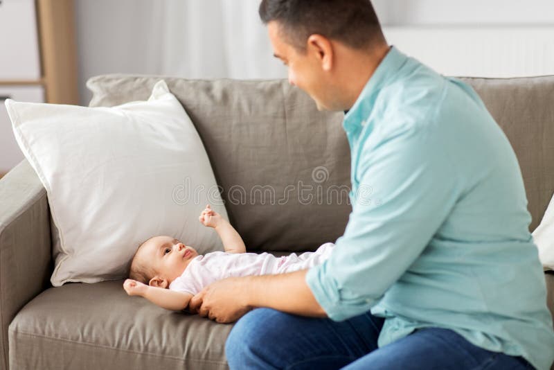 Middle aged father playing with baby at home stock images Middle aged father playing with baby at home stock images