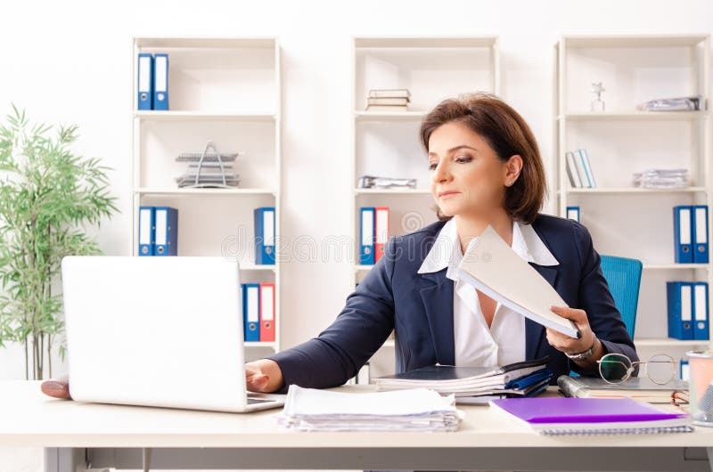 The Middle Aged Female Employee Sitting At The Office Stock Image Image Of Businesslady Bank