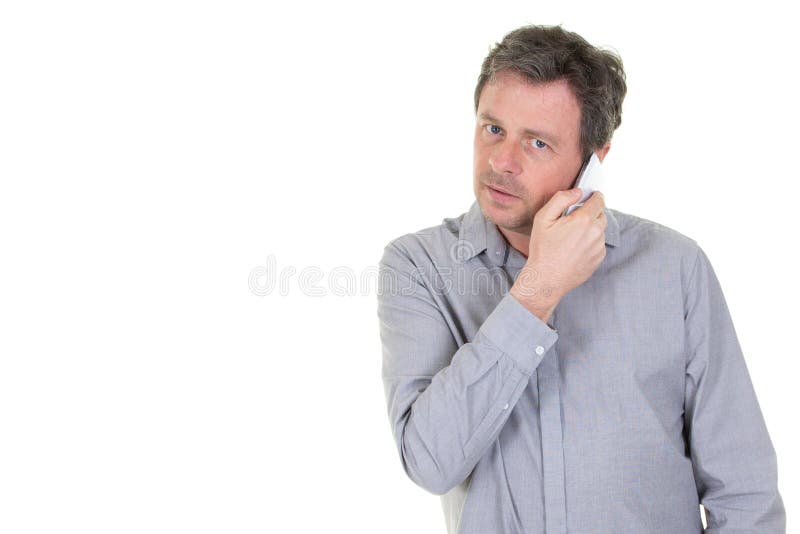 Middle aged man listening on a phone on a white background royalty free stock image