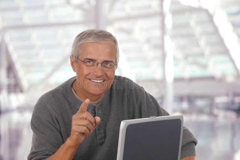 Middle aged man in lobby of modern office