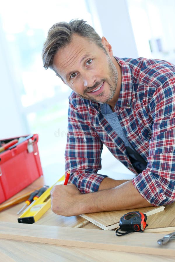 Man working on wood planks for home-improvement. Man working on wood planks for home-improvement