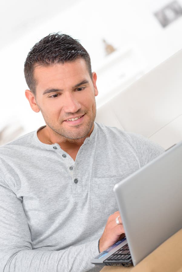 Middle-aged man working from home on laptop computer royalty free stock images Middle-aged man working from home on laptop computer royalty free stock images