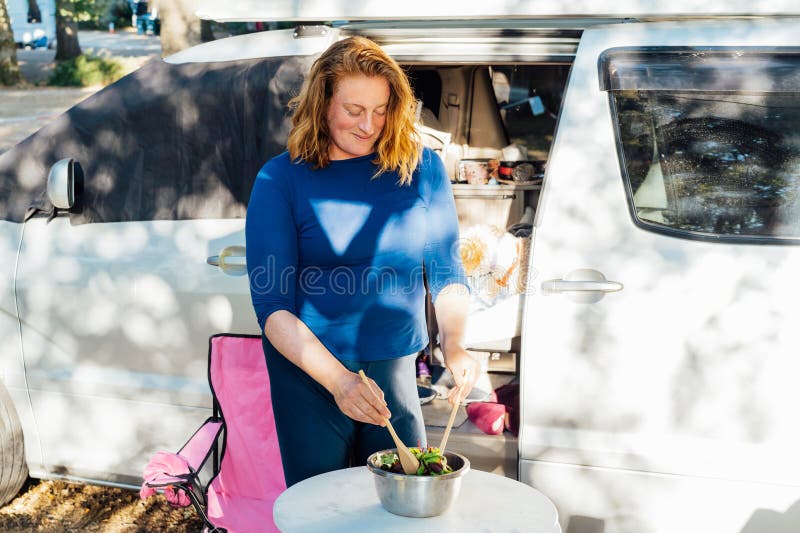https://thumbs.dreamstime.com/b/middle-aged-nomad-woman-cooking-salad-outside-her-camper-van-forest-camp-her-cockapoo-puppy-pet-road-middle-275658673.jpg