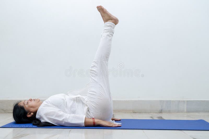 Middle Aged or an Old Indian Woman Performing Yoga Early Morning, in Her  House in White Dress. Stay Home Stay Safe and Fit Stock Photo - Image of  aged, early: 185441270